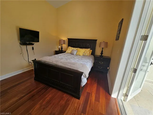 Bedroom featuring baseboards and wood finished floors