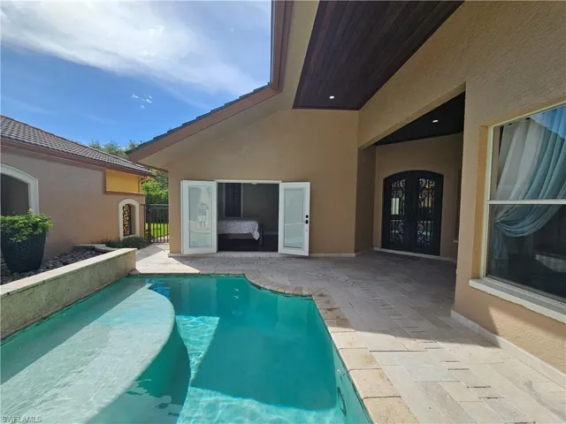 Outdoor pool featuring a patio and french doors