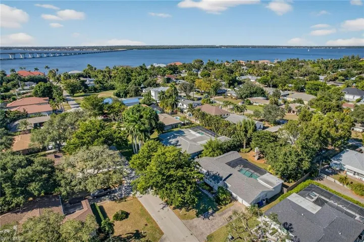Aerial overview of property's location featuring a notable bridge, a large body of water, and nearby suburban area