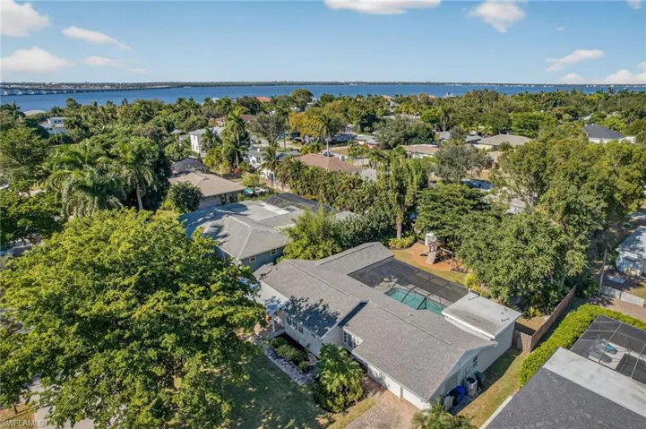 Aerial perspective of suburban area with a nearby body of water