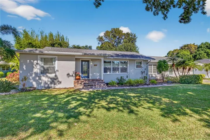 Ranch-style home featuring a front yard and stucco siding
