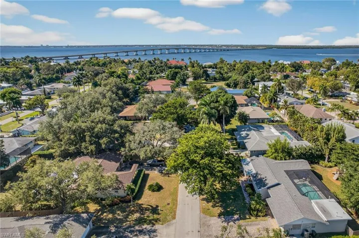 Aerial view of residential area with a notable bridge and a large body of water