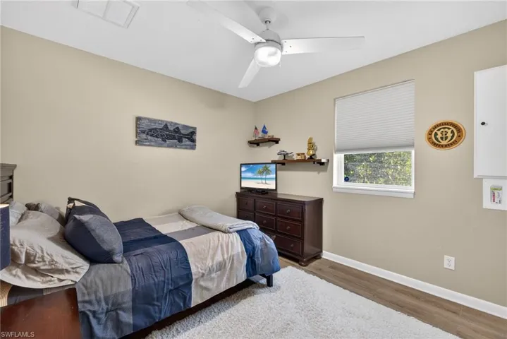 Bedroom with wood finished floors and a ceiling fan