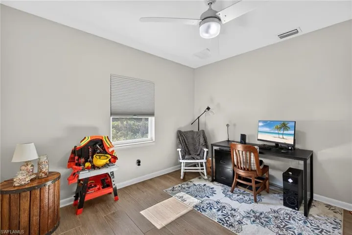 Office featuring wood finished floors and a ceiling fan