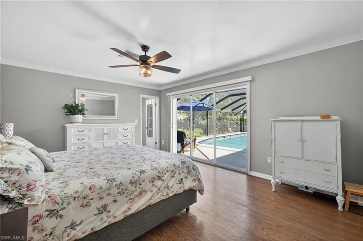 Bedroom with a sunroom, wood finished floors, access to outside, a ceiling fan, and ornamental molding
