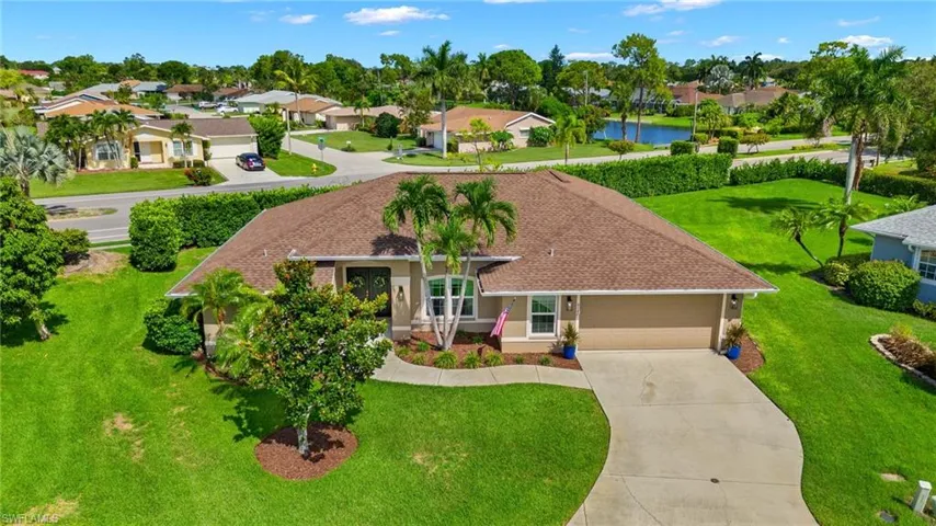 View of front of house featuring a garage and a front lawn