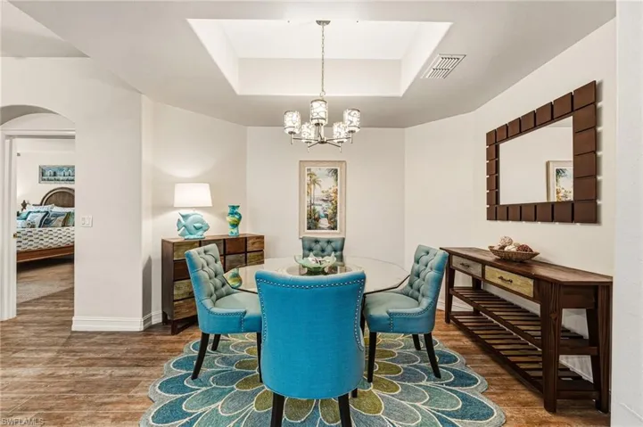The formal dining room is enhanced by custom lighting and a tray ceiling, creating an elegant and inviting setting.