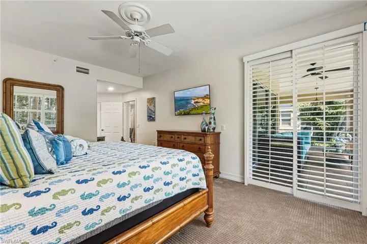 The primary bedroom features upgraded carpeting, plantation shutters, and abundant natural light, along with direct access to the lanai. It also includes a spacious walk-in closet and a well-appointed ensuite bath.