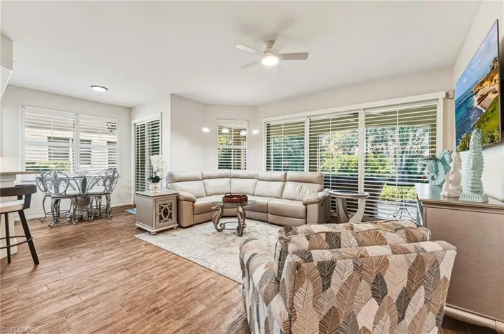 Stunning plantation shutters span the living room sliders and continue into the breakfast room, creating a cohesive and elegant look throughout.