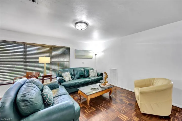 Spacious living-room featuring large window and Brazilian walnut floors.