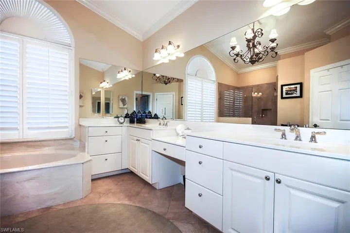 Dual sinks, chandelier, tub and shower