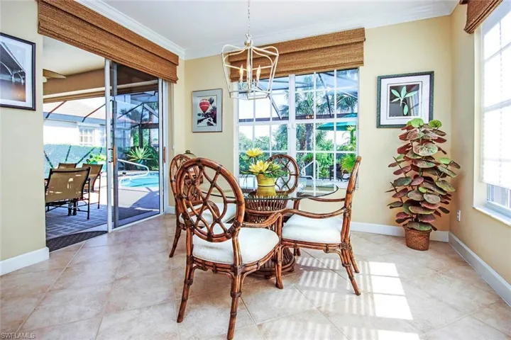 Dining area open to the lanai, crown molding, updated lighting