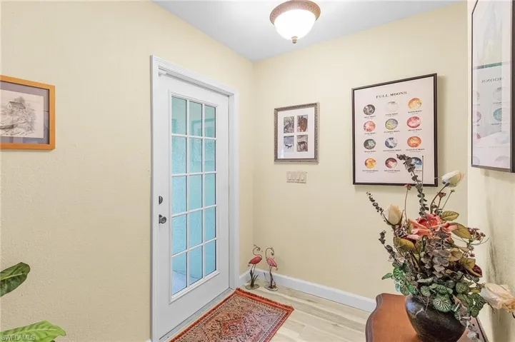 Doorway with light hardwood / wood-style flooring