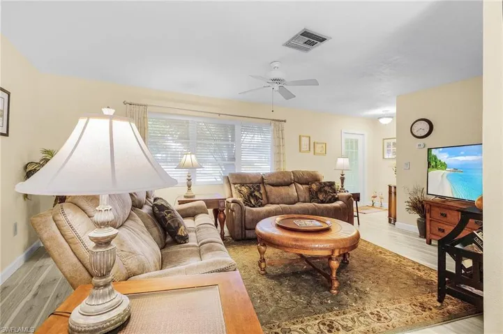 Living room featuring light hardwood / wood-style floors and ceiling fan