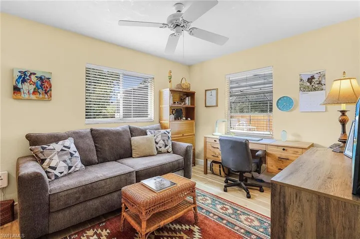 Office space featuring ceiling fan and light hardwood / wood-style flooring