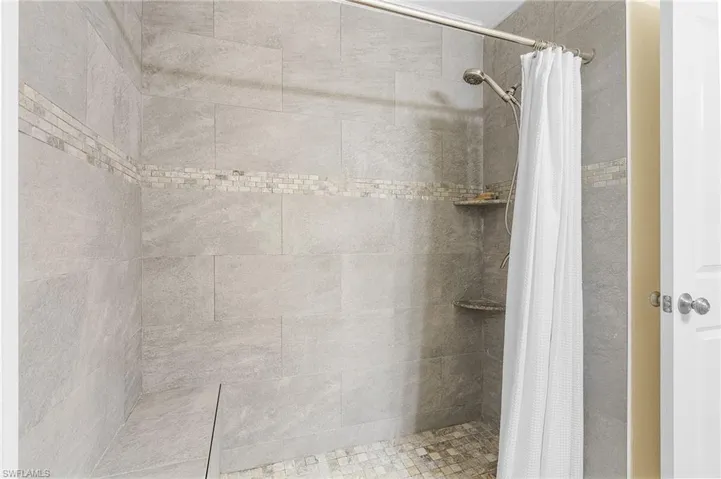 Bathroom featuring a shower with shower curtain