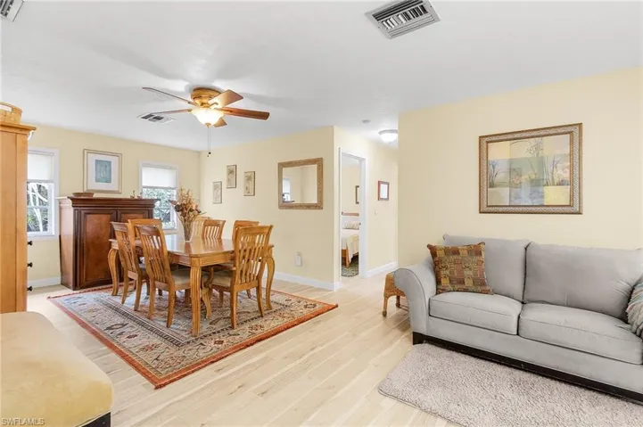 Dining room with light wood-type flooring and ceiling fan
