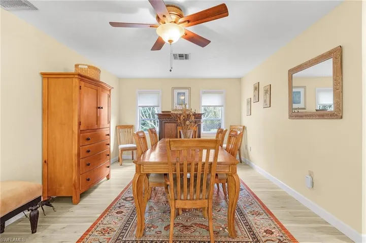Dining room with light wood-type flooring and ceiling fan