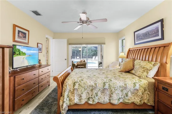 Bedroom with ceiling fan, light hardwood / wood-style floors, and access to outside