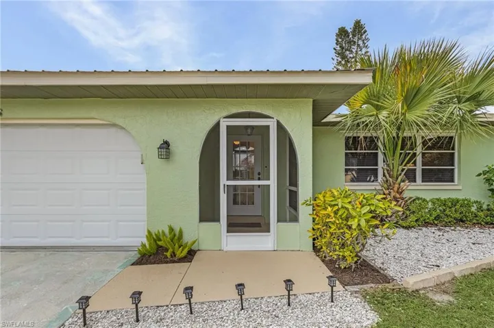 Doorway to property featuring a garage
