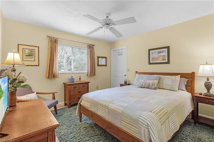 Bedroom with ceiling fan and carpet