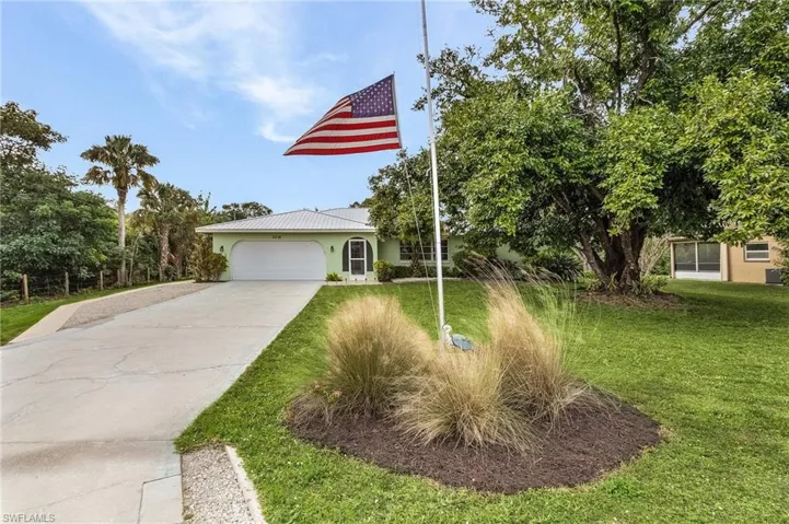 View of front facade with a front lawn and a garage