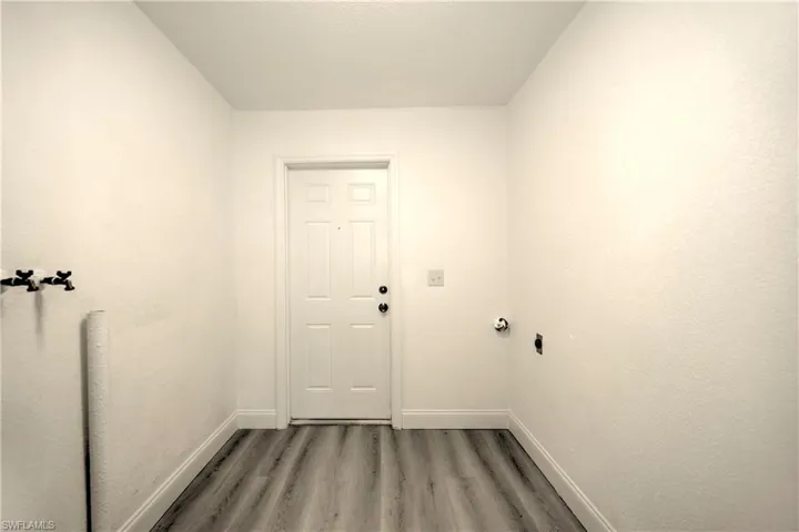 Doorway to outside with wood-type flooring
