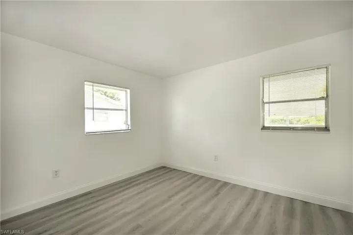 Unfurnished room with hardwood / wood-style flooring