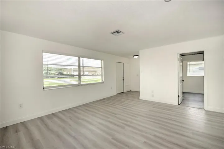 Empty room with light hardwood / wood-style flooring