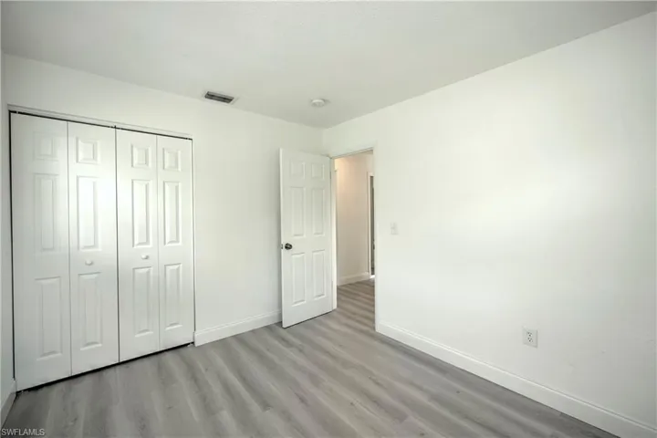 Unfurnished bedroom with light hardwood / wood-style floors and a closet