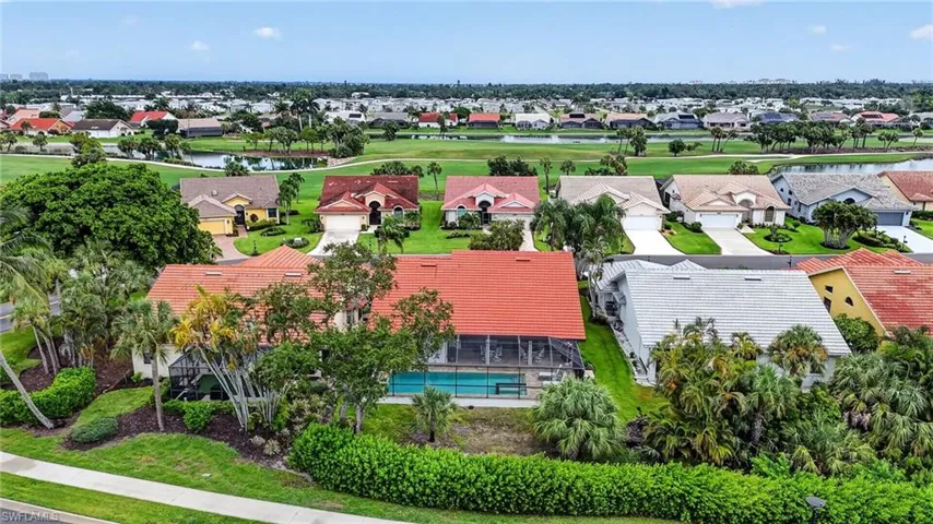 Aerial perspective of a residential community featuring diverse architectural styles and lush landscaping