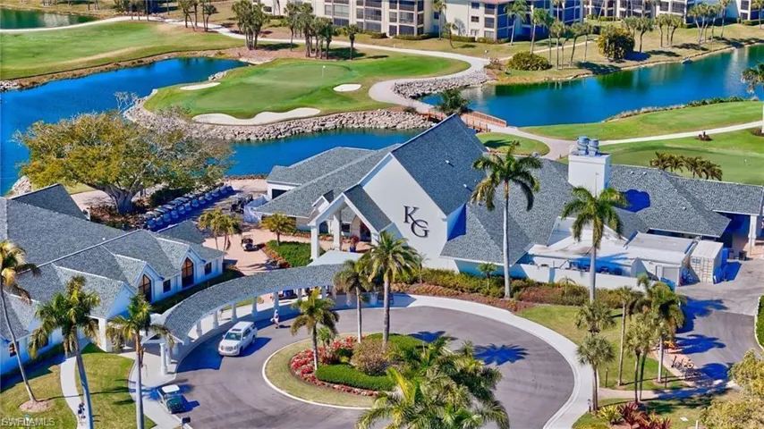 Expansive golf course property featuring a central clubhouse with a covered drive-through entrance