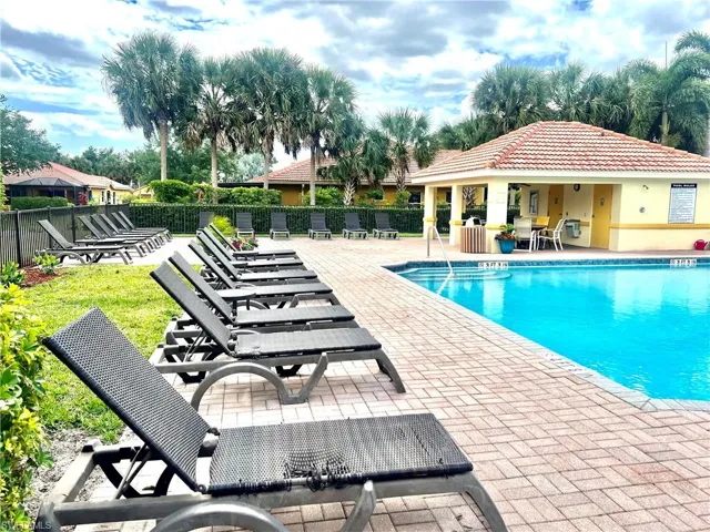 Pool featuring fence and a patio area