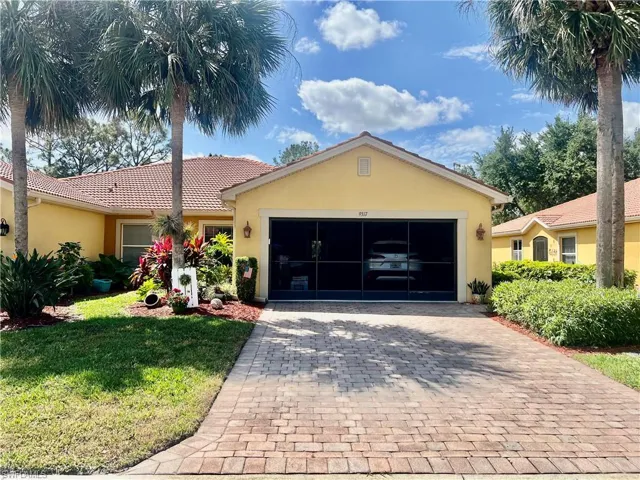 Ranch-style home with a front yard, stucco siding, and am screened garage