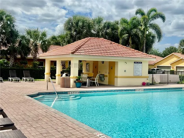 Community pool featuring fence, a gazebo, and a patio area