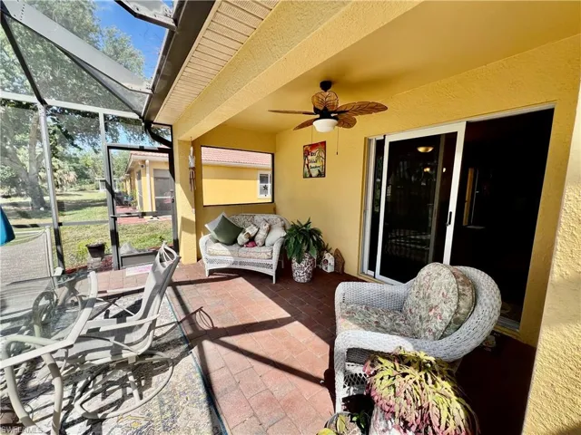 View of patio with screen enclosure and a ceiling fan