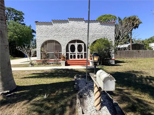Back of property with stucco siding and french doors