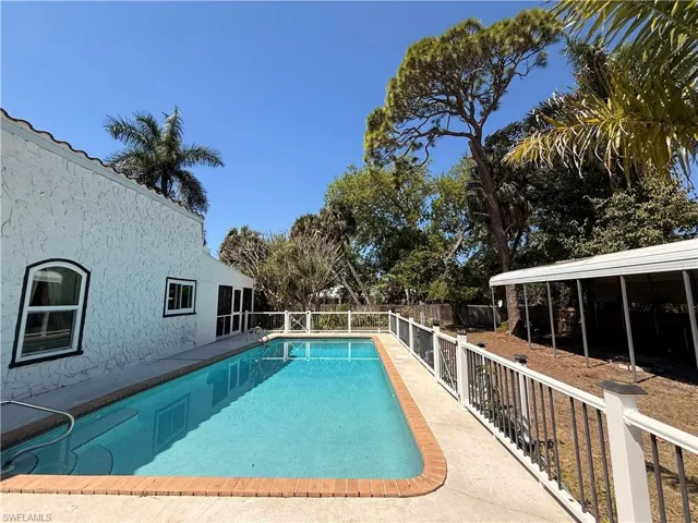 View of swimming pool and a fenced backyard