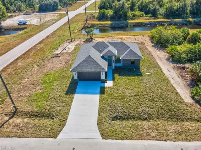 Aerial view of property and surrounding area with a large body of water