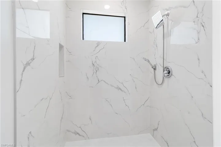 Bathroom with a marble finish shower