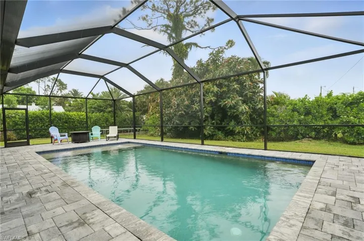 Outdoor pool with a patio and a lanai