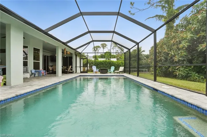 Outdoor pool featuring a patio, ceiling fan, and a lanai