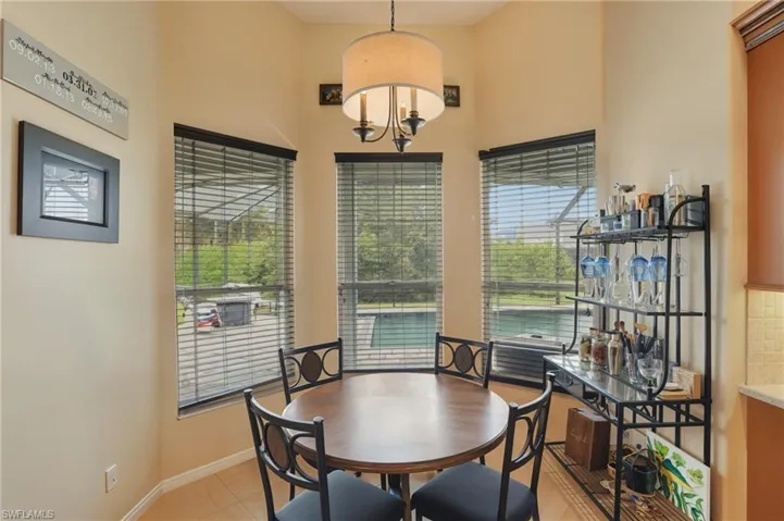 Dining room with baseboards and a towering ceiling