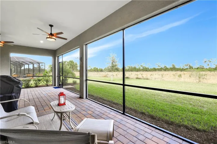 Unfurnished sunroom featuring ceiling fan