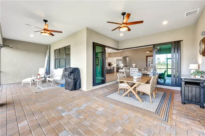 Dining space featuring brick floor, recessed lighting, visible vents, and ceiling fan