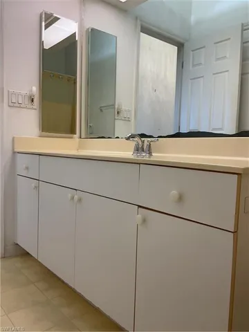 Bathroom featuring tile patterned floors and vanity