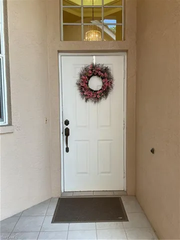 Doorway to property featuring stucco siding