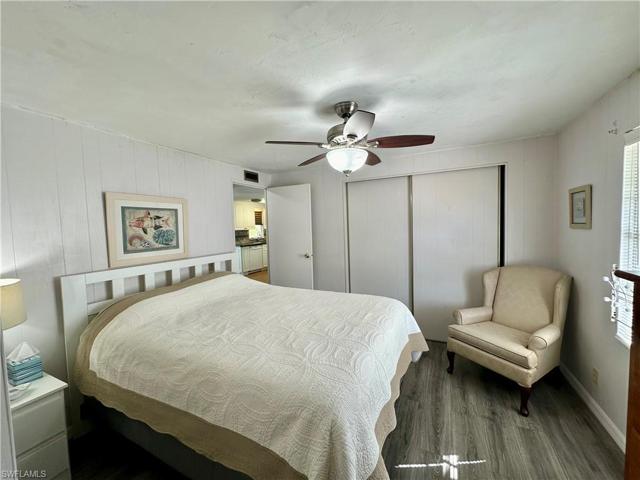 Guest Bedroom with ceiling fan and laminate floor.
