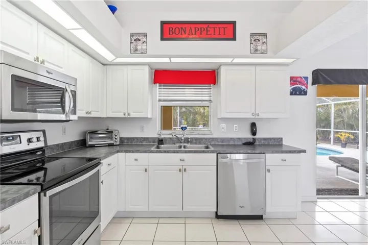 Bright kitchen featuring a sliding door leading to the pool.