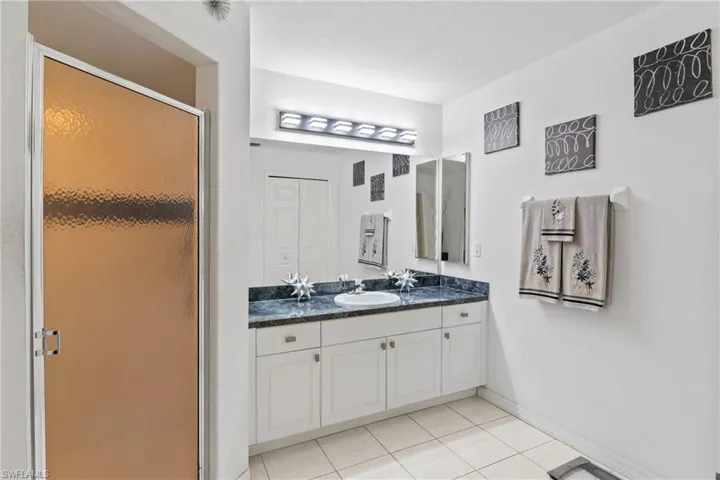 Simple and functional primary bathroom with walk-in shower.